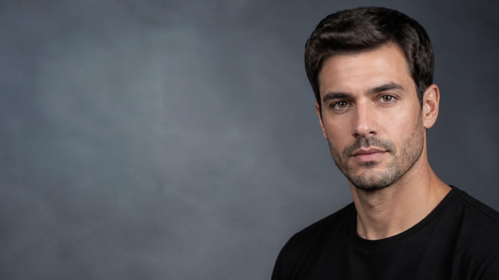 Portrait of a man against a blue-grey studio backdrop