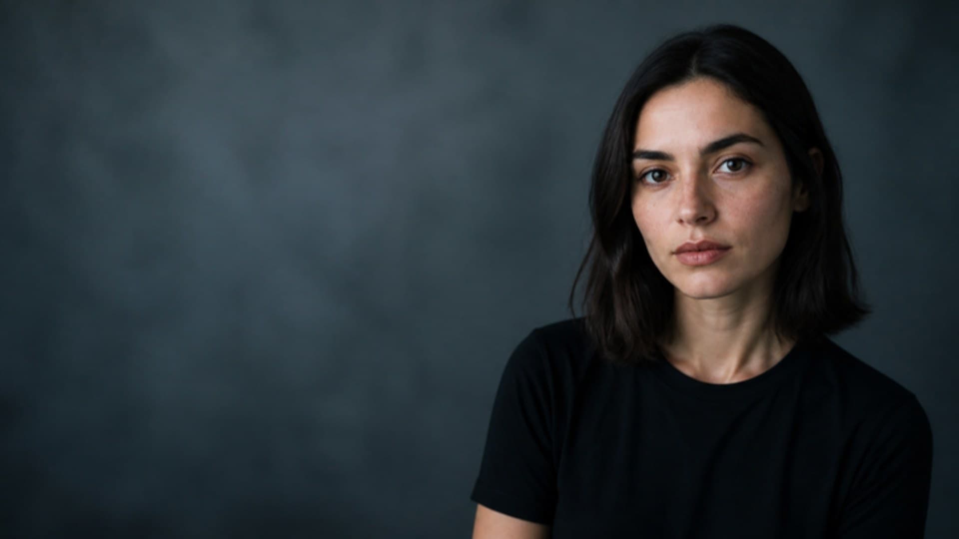 Portrait of a woman against a blue-grey backdrop